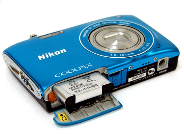 Nikon Coolpix S3100 camera with open battery compartment.