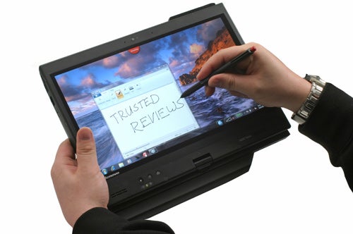 Person using stylus on Lenovo ThinkPad X220 Tablet screen.