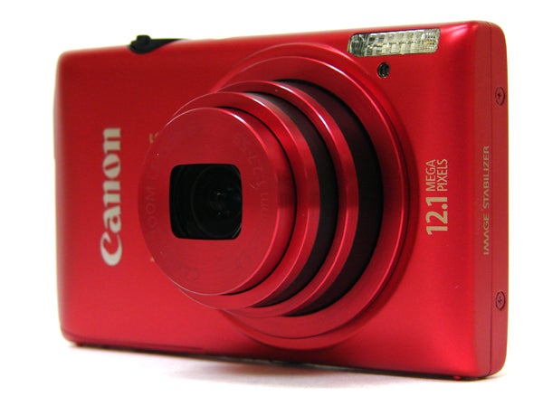 Red Canon IXUS 220 HS digital camera with lens extended.