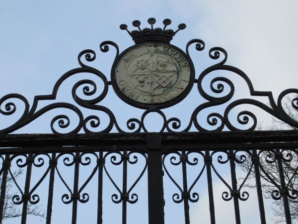 Ornate gate with a circular emblem at the top center.