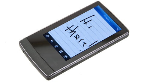 Cowon J3 mp3 player with handwritten note on screen.