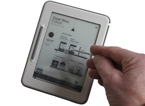 Hand holding iRiver Cover Story EB05W e-reader.