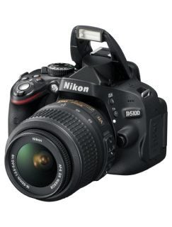 Nikon D5100 DSLR camera with lens and raised flash.