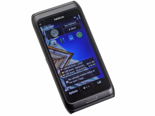 Nokia E7 smartphone displaying home screen on white background