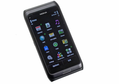 Nokia E7 smartphone with illuminated screen displaying apps.