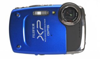 Blue Fujifilm FinePix XP30 camera on white background.