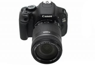 Canon EOS 600D DSLR camera with lens on white background.