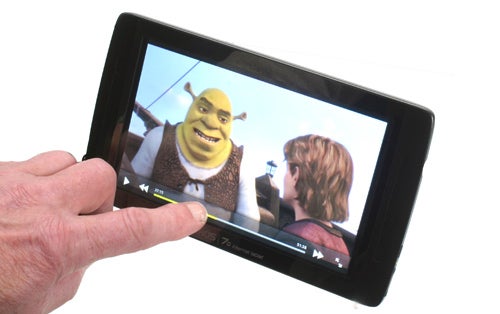 Hand holding Archos 70 tablet displaying Shrek movie scene.