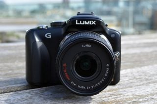 Panasonic Lumix G3 camera on a wooden surface.