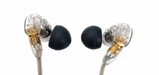 Shure SE215 earphones with clear housing and black ear tips.