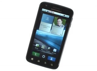 Motorola Atrix smartphone on display with screen visible.