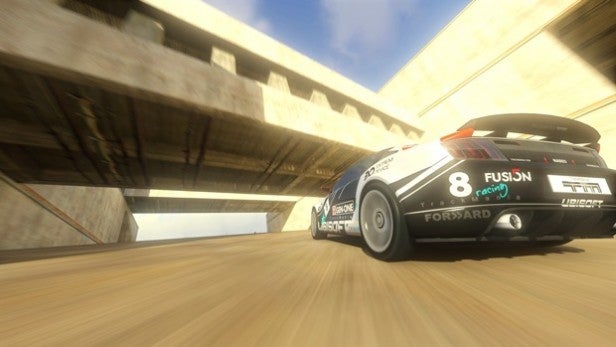 Racing car driving on a canyon track in Trackmania 2.