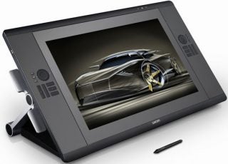 Wacom Cintiq 24HD graphics tablet with stylus and artwork.