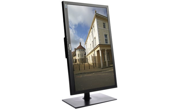 Samsung S27A850D monitor in portrait orientation displaying cityscape.
