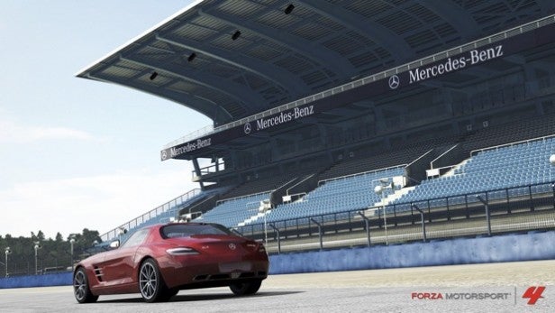 Red sports car on track in Forza Motorsport 4 game.