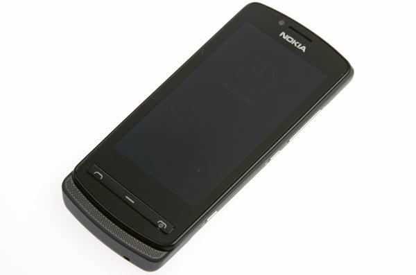 Nokia 700 3Nokia 700 smartphone lying on a white surface.