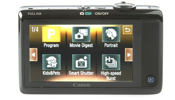 Canon IXUS 1100 HS camera showing settings on LCD screen.Canon IXUS 1100 HS camera displaying a nighttime cityscape photo.