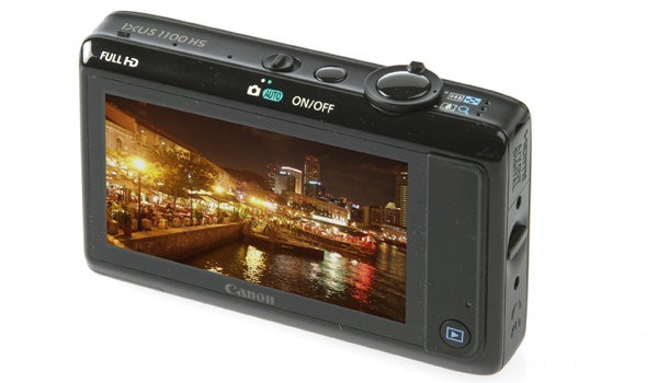 Canon IXUS 1100 HS camera displaying a nighttime cityscape photo.