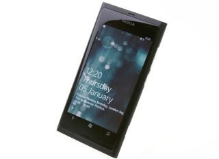 Nokia Lumia 800 smartphone displaying date and time on screen.