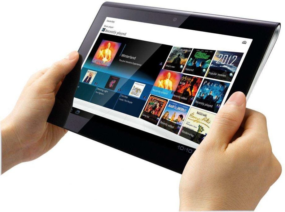 Hand holding a Sony Tablet S displaying multimedia content.