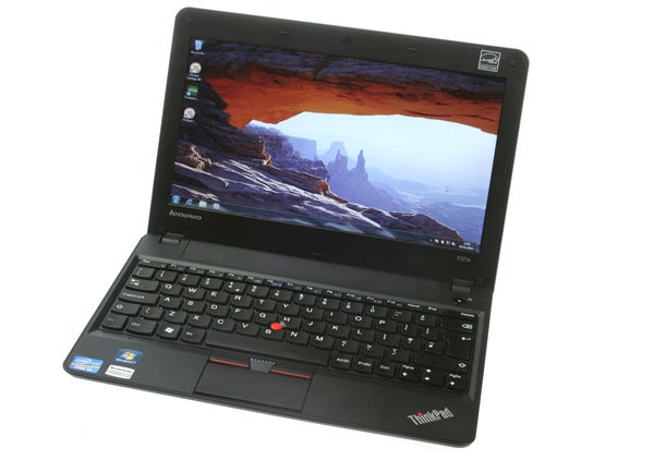 Lenovo ThinkPad X121e laptop with open screen displaying wallpaper
