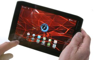 Hands holding a Motorola Xoom 2 Media Edition tablet.
