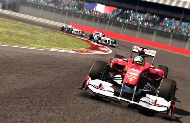 F1 2011Racing game screenshot with Xbox 360 racing wheel perspective.