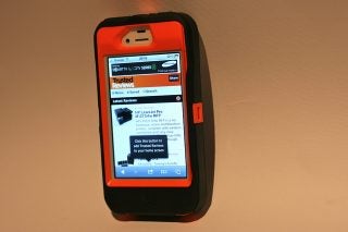 iPhone in orange and black Otterbox Defender case