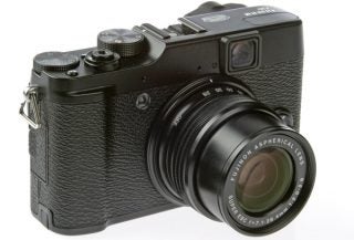 Fujifilm X10 camera with lens extended on white background.