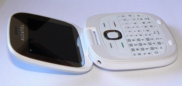 Alcatel OT-810 flip phone open on a white surface.