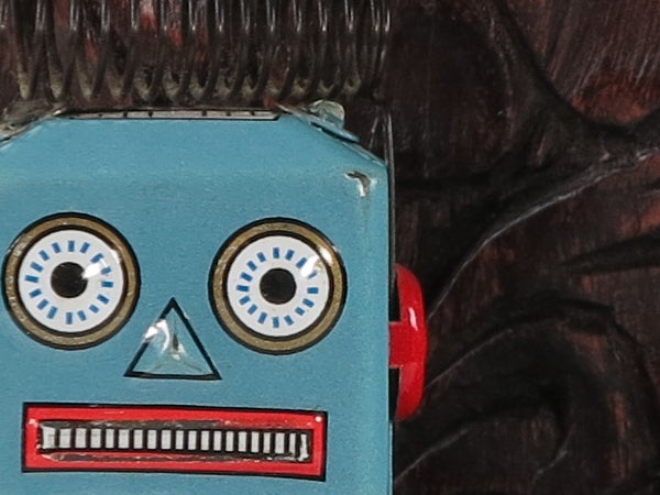 Close-up of a vintage blue toy robot's face