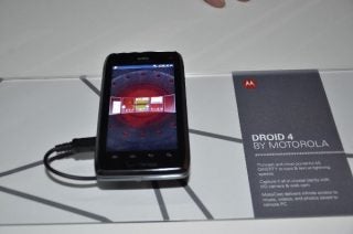 Motorola Droid 4 smartphone on display next to information card.