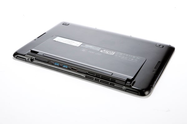 Acer Aspire S5 laptop showing ports and underside label.