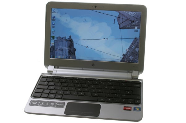 HP Pavilion dm1-3200sa laptop with open lid displaying desktop screen.
