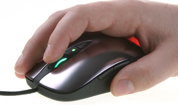 Hand using SteelSeries Sensei gaming mouse with illuminated buttons.