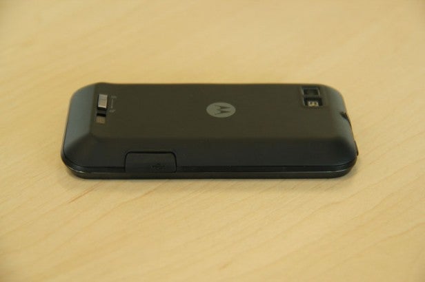 Motorola Defy Mini smartphone lying on a wooden surface.