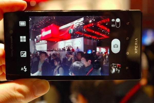 Sony Xperia Ion smartphone capturing a photo at an event.