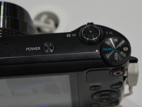 Close-up of Samsung WB150F camera's control dials and power button.