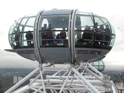 Close-up of a London Eye capsule with people inside.