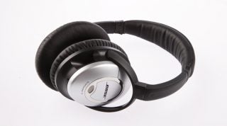 Bose QuietComfort 15 noise-cancelling headphones on white background.