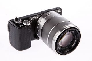 Sony NEX-5N camera with lens on white background.