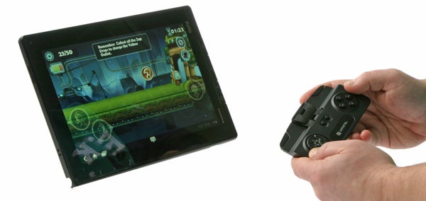 Hand holding Gametel Bluetooth Controller with game on tablet screen