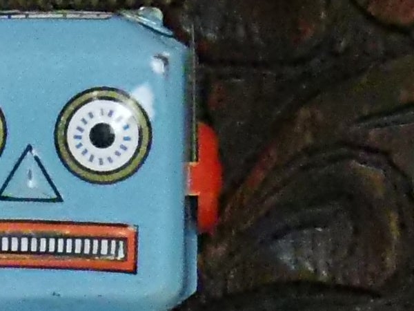 Close-up of a blue toy robot face.