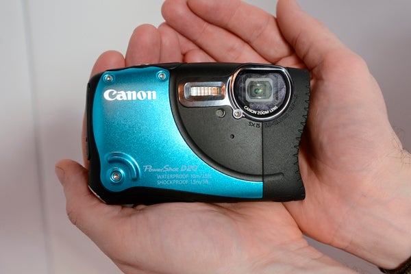 Hand holding Canon PowerShot D20 waterproof camera.