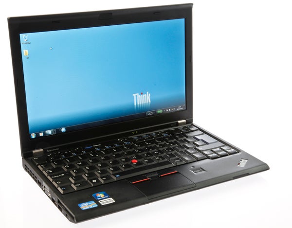 Lenovo ThinkPad X220 laptop with open lid and powered on