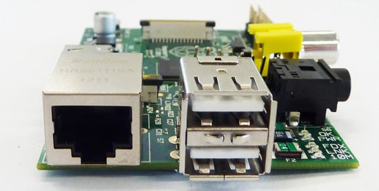 Raspberry Pi single-board computer on a white background.Close-up of a Raspberry Pi circuit board with connectors.
