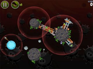 Angry Birds Space game screenshot with planets and pigs.