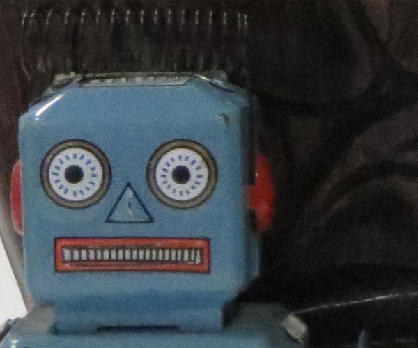 Vintage blue toy robot with a background.Vintage blue toy robot face close-up.
