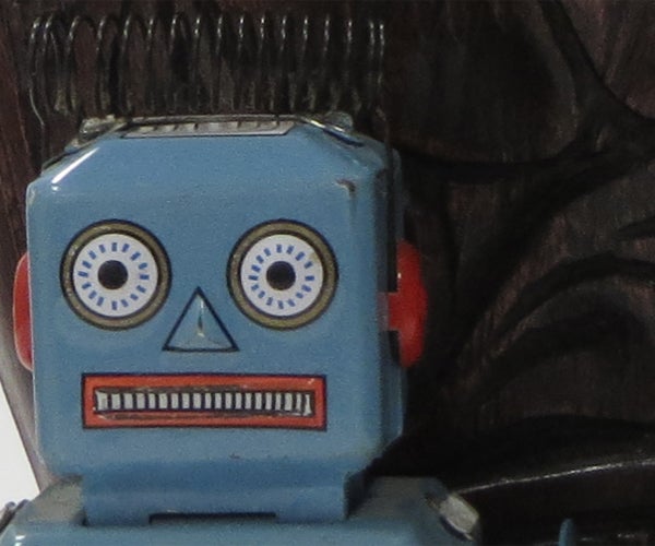 Vintage blue toy robot with a background.Vintage blue toy robot face close-up.Close-up of a vintage toy robot with blue faceClose-up of a vintage blue toy robot's face.Close-up of a toy robot's face.