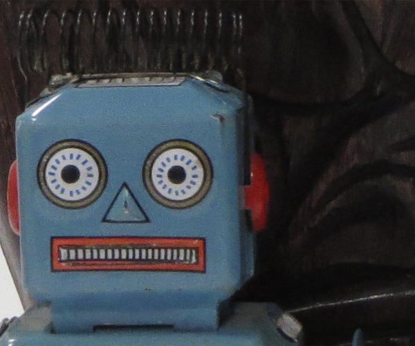 Vintage blue toy robot with a background.Vintage blue toy robot face close-up.Close-up of a vintage blue toy robot's face.Close-up of a toy robot's face.
